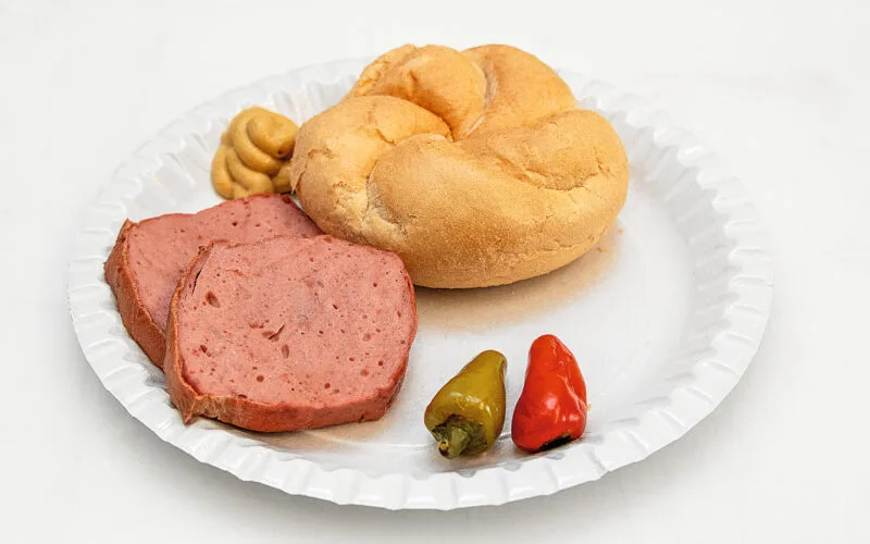 Herzhafte Jause: selbst gemachter Wildleberkäse mit Senf, Pfefferoni und Semmel.