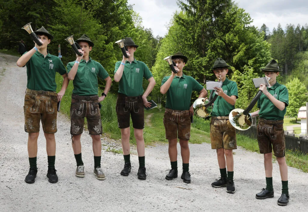 Junge Jagdhornbläser spielen im Freien